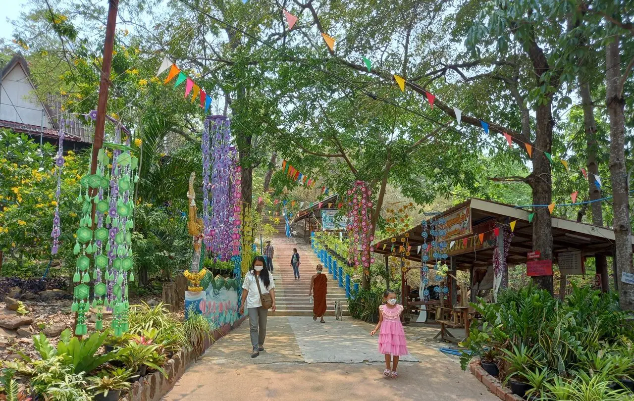 Phutthasathan Phu Po in Kalasin, featuring ancient reclining Buddha reliefs carved into natural sandstone cliffs